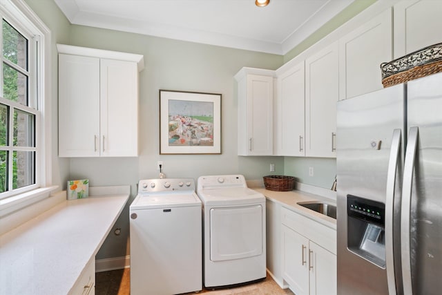 laundry area featuring laundry area, plenty of natural light, separate washer and dryer, and crown molding