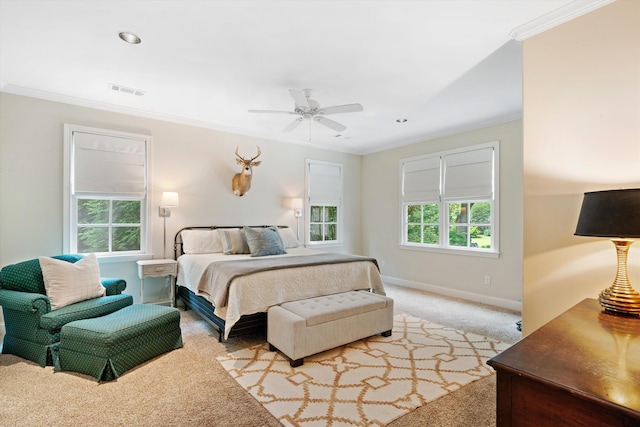 bedroom with visible vents, baseboards, a ceiling fan, light colored carpet, and crown molding