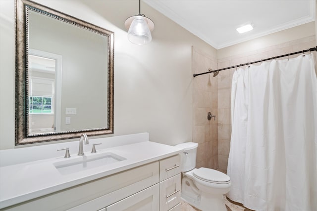 bathroom with toilet, crown molding, a tile shower, and vanity