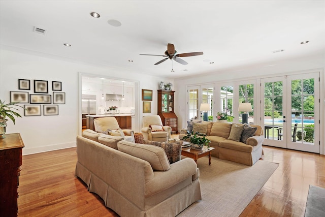 living area with french doors, recessed lighting, visible vents, and baseboards