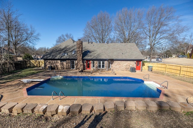 view of swimming pool with a fenced in pool, cooling unit, a fenced backyard, and a patio