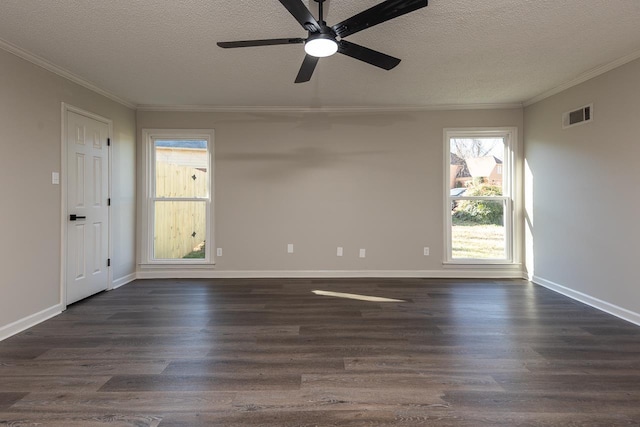 spare room with a textured ceiling, dark wood-style flooring, visible vents, and crown molding