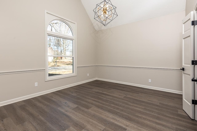 unfurnished room with lofted ceiling, dark wood-style floors, baseboards, and a notable chandelier