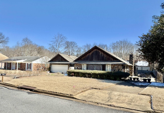 view of front of property with an attached garage and a chimney