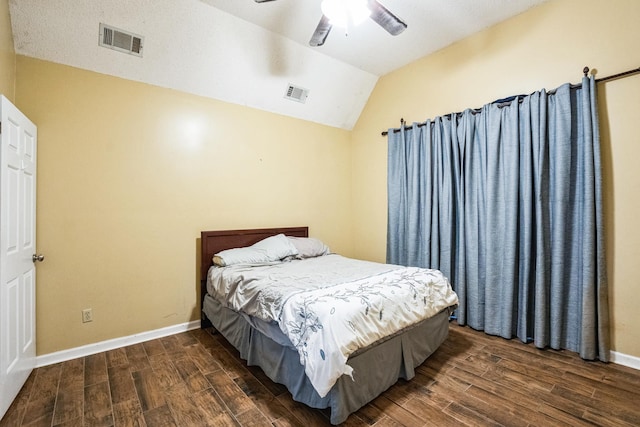 bedroom with lofted ceiling, visible vents, and wood finished floors