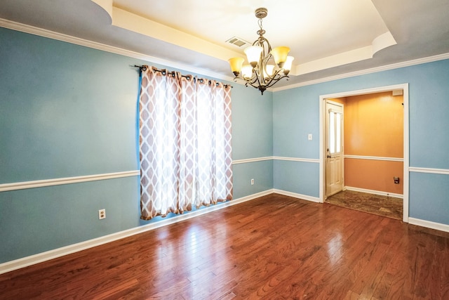 unfurnished room featuring baseboards, visible vents, wood-type flooring, a tray ceiling, and a notable chandelier