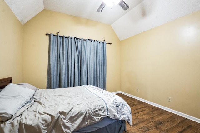 bedroom with lofted ceiling, ceiling fan, dark wood-style floors, and baseboards