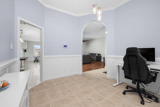 office area with ornamental molding, arched walkways, wainscoting, and light tile patterned floors