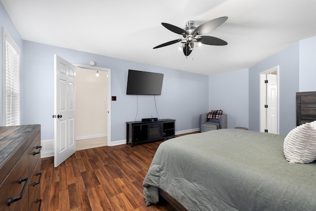 bedroom with visible vents, baseboards, dark wood finished floors, and a ceiling fan