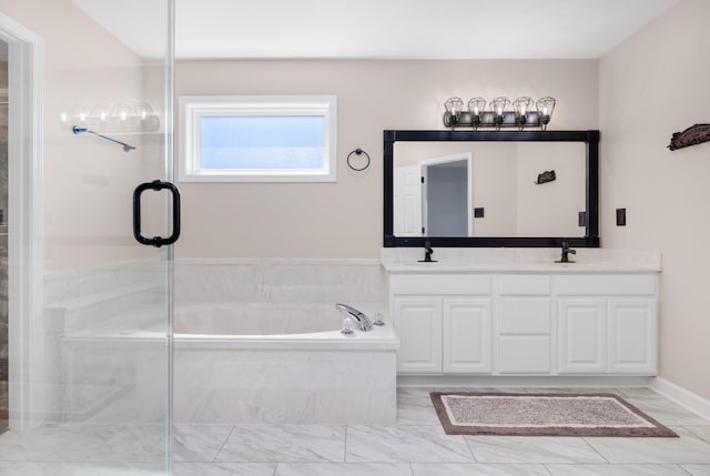 bathroom with double vanity, a stall shower, marble finish floor, a garden tub, and a sink