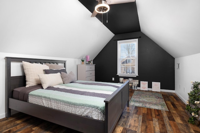 bedroom with dark wood-style floors, vaulted ceiling, a ceiling fan, and baseboards