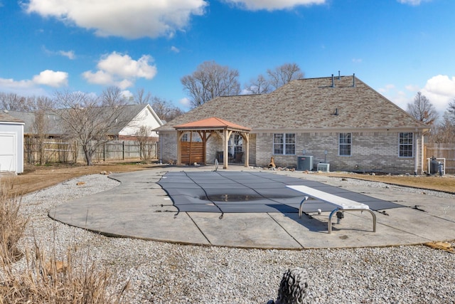 view of swimming pool with a fenced in pool, a patio, a gazebo, central AC, and fence