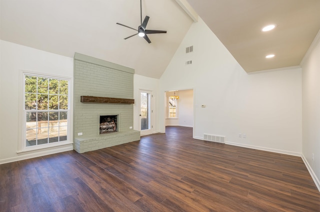 unfurnished living room with a ceiling fan, visible vents, a fireplace, and dark wood-style floors