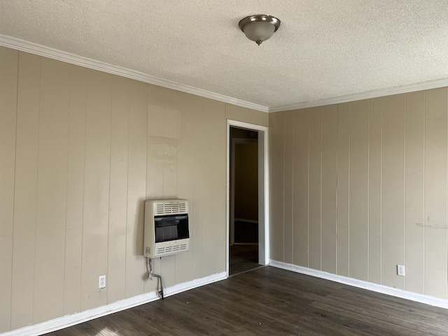 empty room featuring crown molding, a textured ceiling, dark wood finished floors, and heating unit