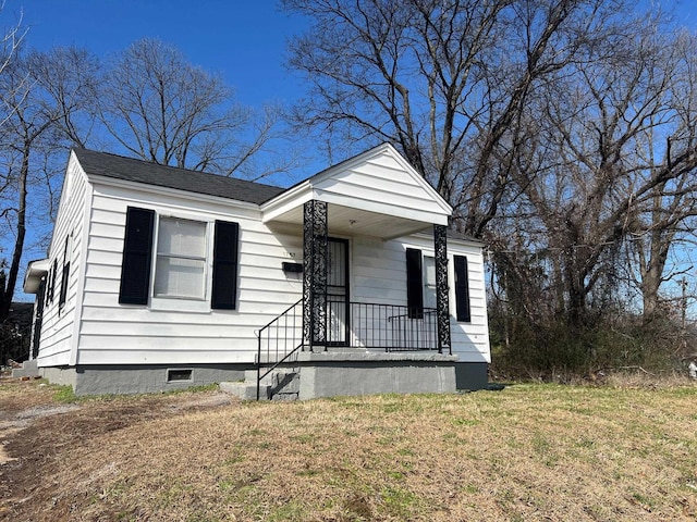 bungalow-style home with crawl space, covered porch, a shingled roof, and a front lawn