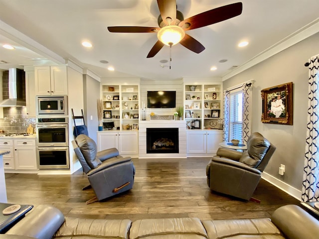 living room with a fireplace, recessed lighting, ornamental molding, wood finished floors, and baseboards