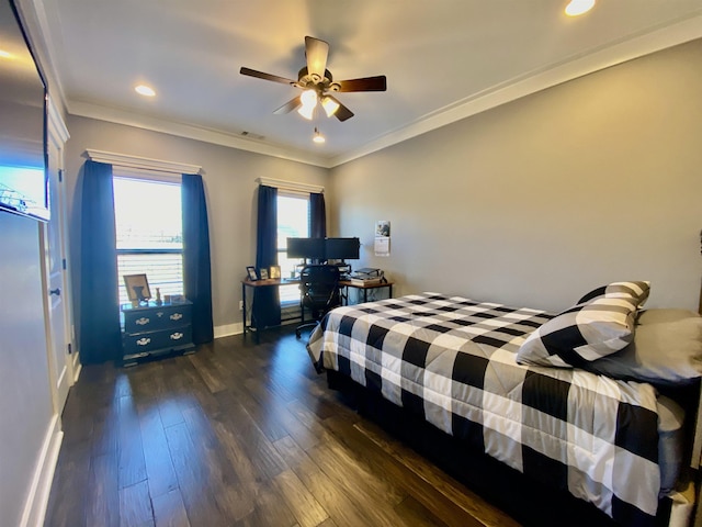 bedroom with visible vents, dark wood-type flooring, ornamental molding, a ceiling fan, and baseboards