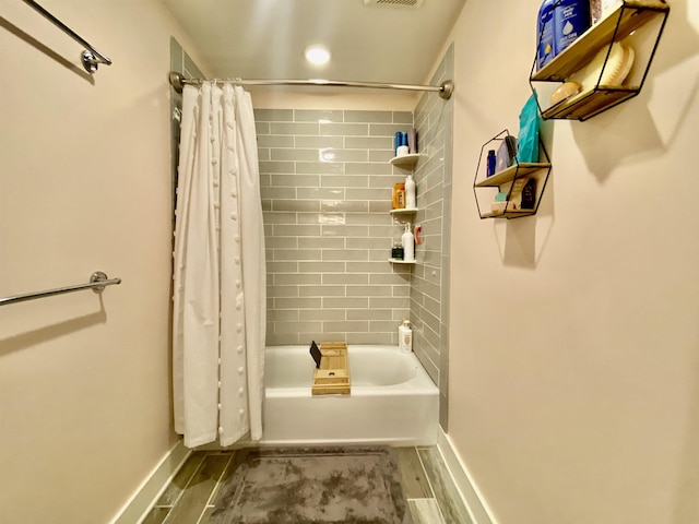 full bath with shower / tub combo, baseboards, and visible vents