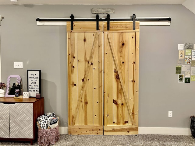 interior space with carpet floors and a barn door