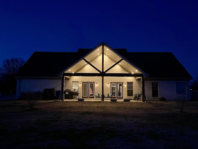 view of back of house at night