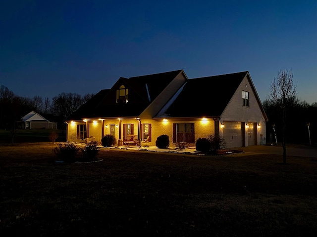 back of house at twilight with driveway