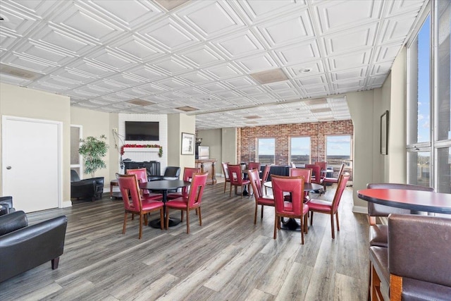 dining room with a fireplace, wood finished floors, and an ornate ceiling