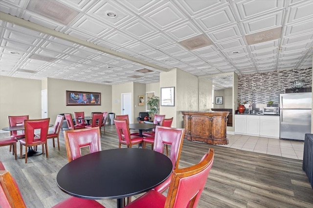 dining room featuring wood finished floors and an ornate ceiling