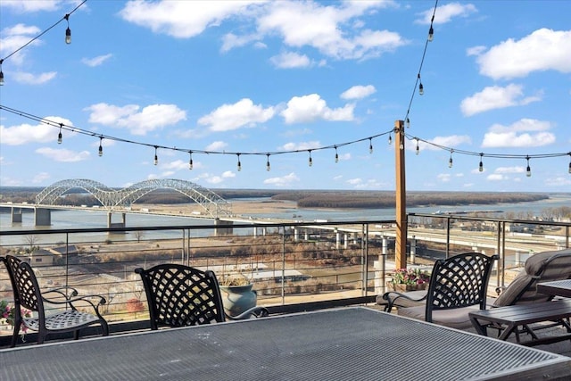 view of patio / terrace featuring a water view and a balcony