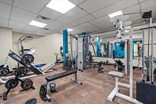 workout area featuring a paneled ceiling and visible vents