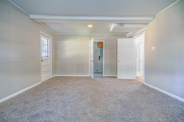 spare room with baseboards, carpet, visible vents, and crown molding