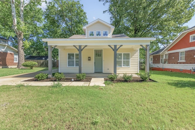 bungalow featuring a porch, a front yard, and fence