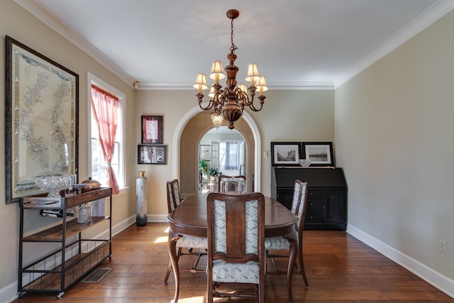 dining area with a chandelier, arched walkways, visible vents, and dark wood finished floors