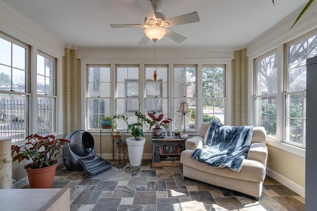 sunroom featuring a ceiling fan