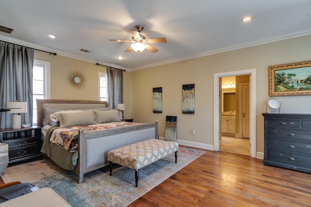 bedroom featuring recessed lighting, wood finished floors, visible vents, baseboards, and ornamental molding