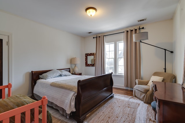 bedroom featuring light wood-style floors and visible vents