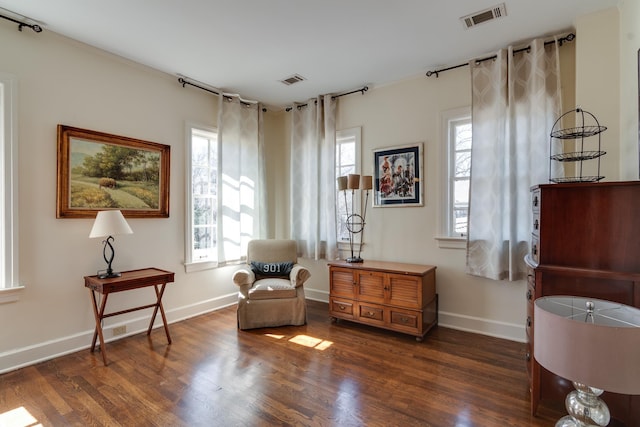 sitting room featuring dark wood-style floors, visible vents, and baseboards