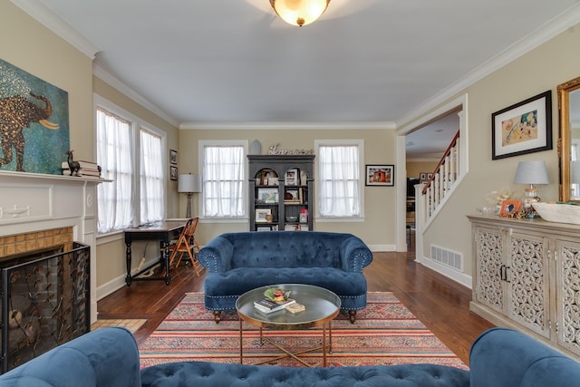 living area featuring stairs, visible vents, dark wood finished floors, and ornamental molding