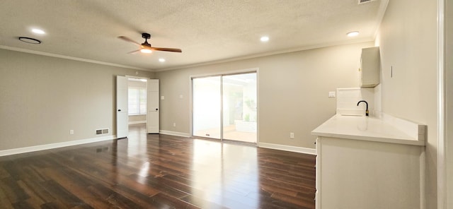 interior space featuring dark wood-style floors, baseboards, visible vents, and crown molding