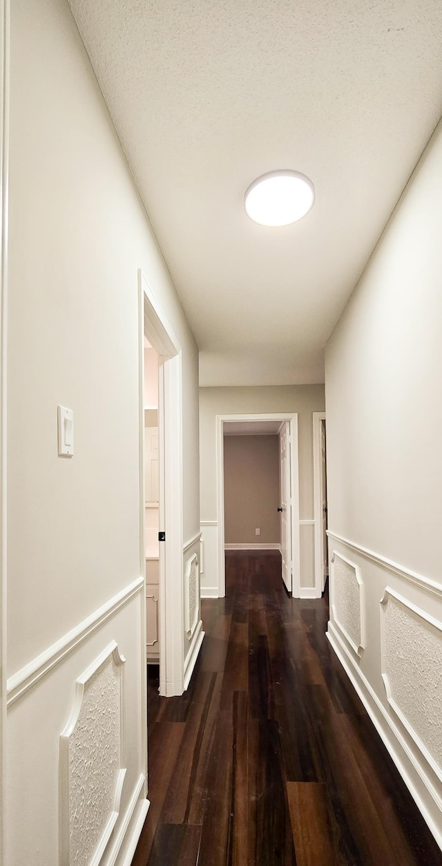 hallway featuring dark wood-type flooring