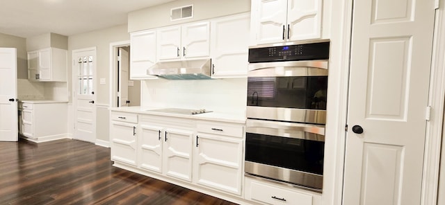 kitchen featuring visible vents, light countertops, double oven, under cabinet range hood, and black electric cooktop