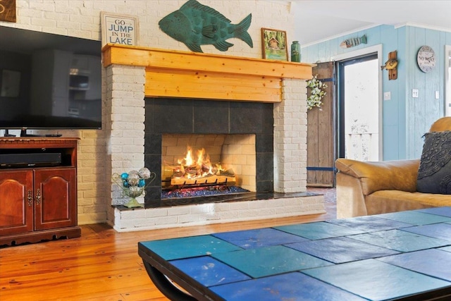 interior space featuring a warm lit fireplace and light wood-type flooring