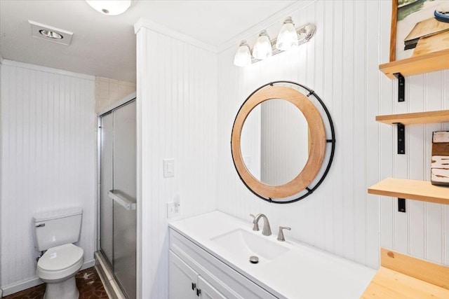 full bathroom with vanity, a shower stall, and toilet