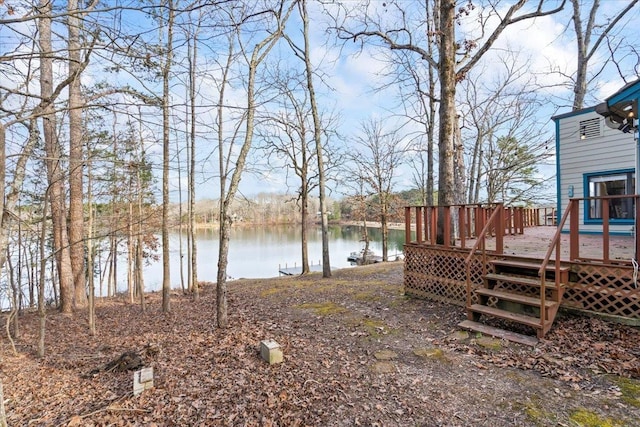 view of yard featuring a deck with water view