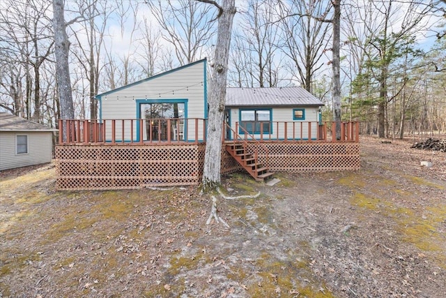 rear view of property with metal roof and a deck