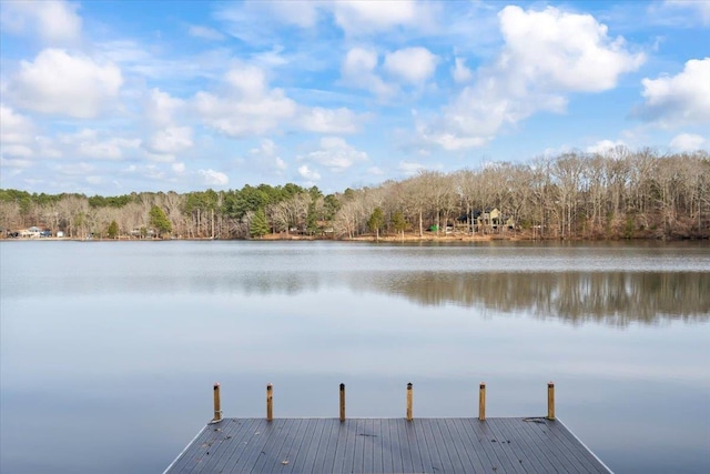 dock area featuring a forest view and a water view