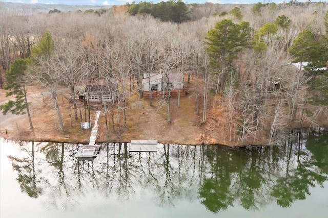 aerial view featuring a forest view and a water view