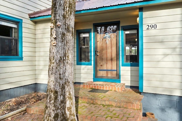 doorway to property with metal roof