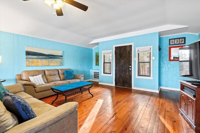 living room with lofted ceiling, wood finished floors, a ceiling fan, baseboards, and ornamental molding