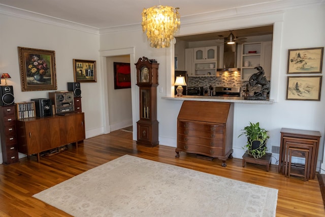 interior space with tasteful backsplash, crown molding, and wood finished floors