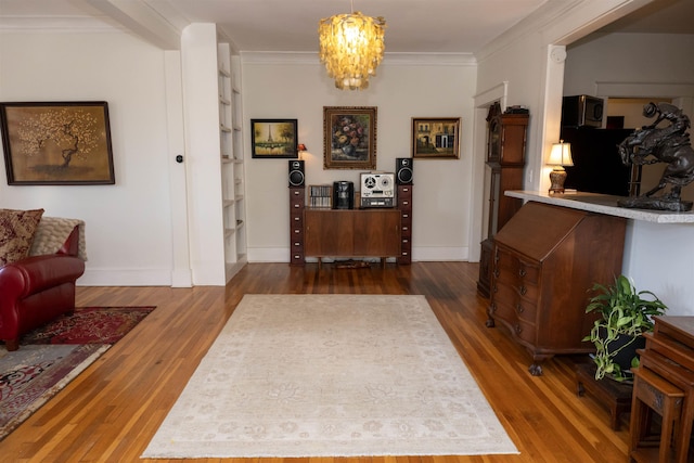 foyer featuring a notable chandelier, baseboards, dark wood finished floors, and crown molding